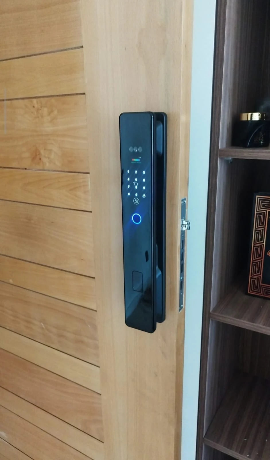 Serrure intelligente XR Max photographiée sur une porte entrouverte au Maroc, réalisation Binaa.